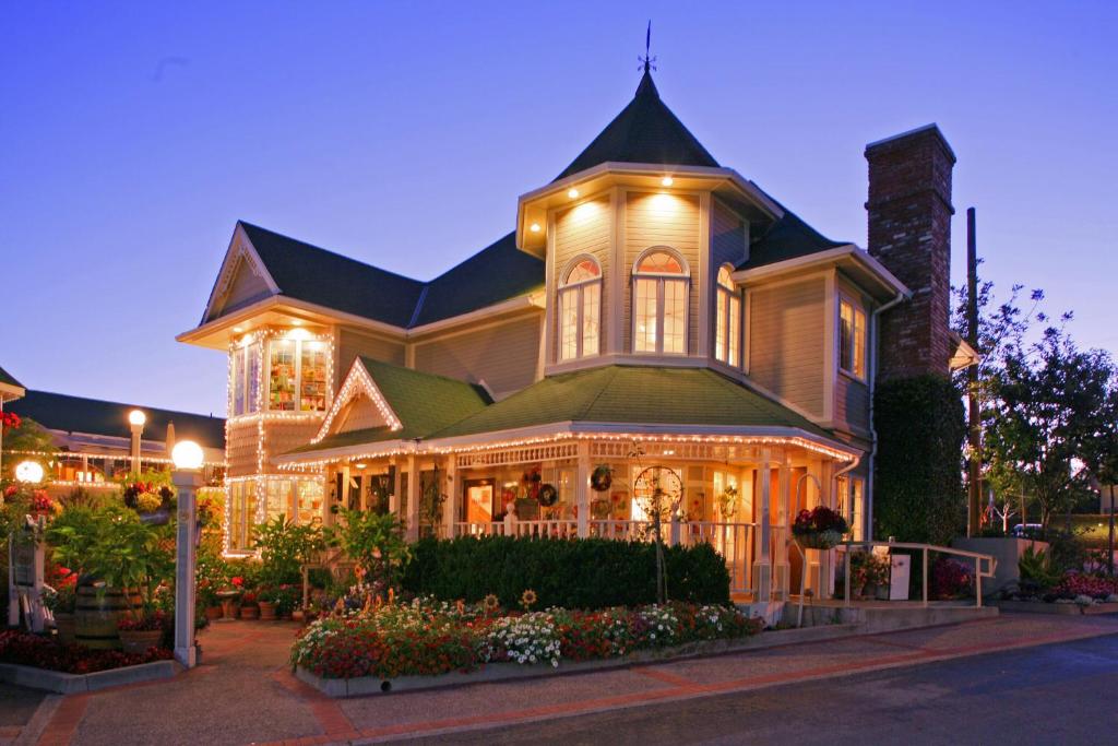a large house with a clock on the front of it at Apple Farm Inn in San Luis Obispo