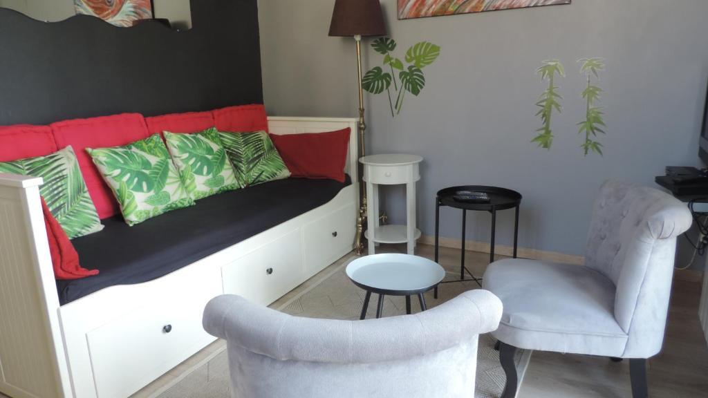 a bedroom with a bed with a couch and a chair at Le Mas de Cascabel in Causse et Diege