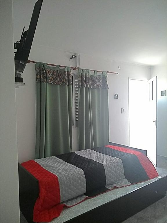 Una cama o camas en una habitación de Departamentos Victorino