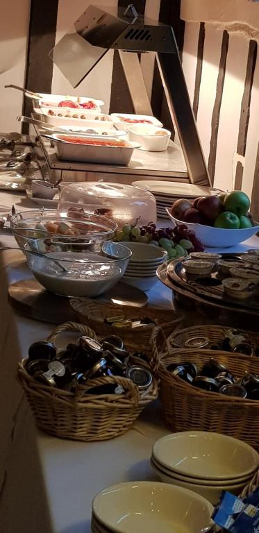 a table with baskets of food and other dishes at The Tudor Hotel in Harrow
