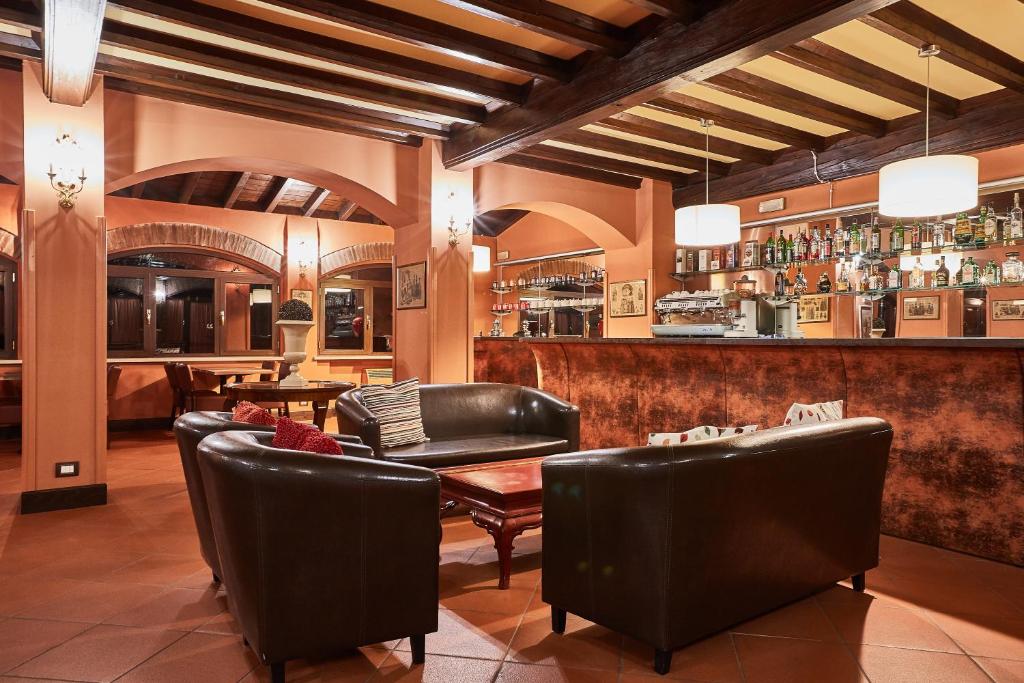 restauracja ze skórzanymi krzesłami i barem w obiekcie Albergo Trattoria Il Leone w mieście Pomponesco