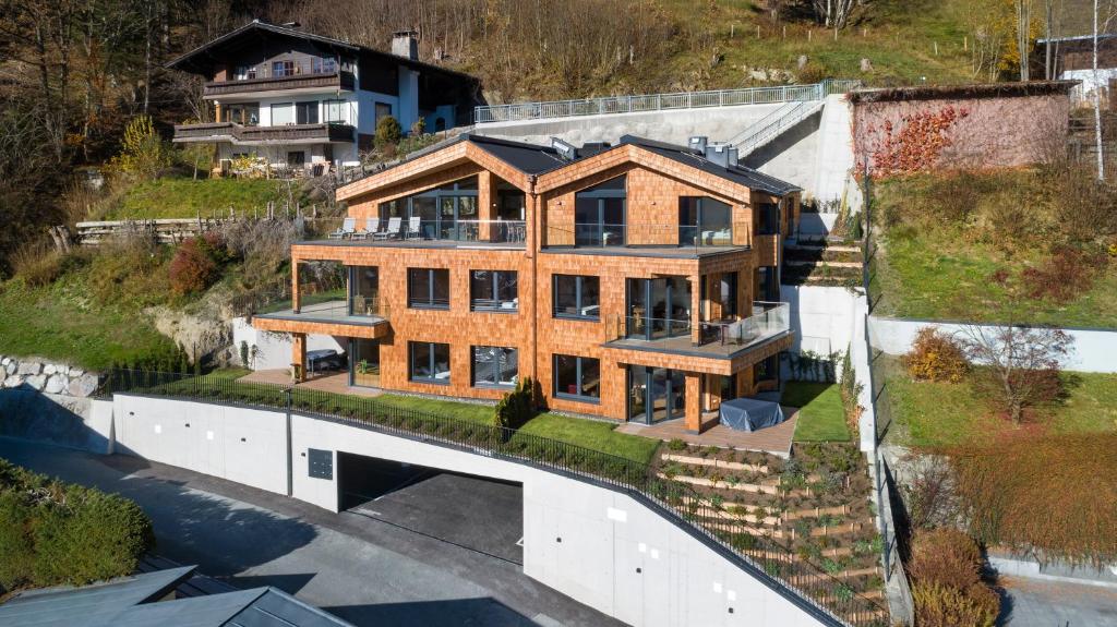 - une vue sur une maison en bois avec une cour dans l'établissement Apartments Adlerhorst, à Zell am See