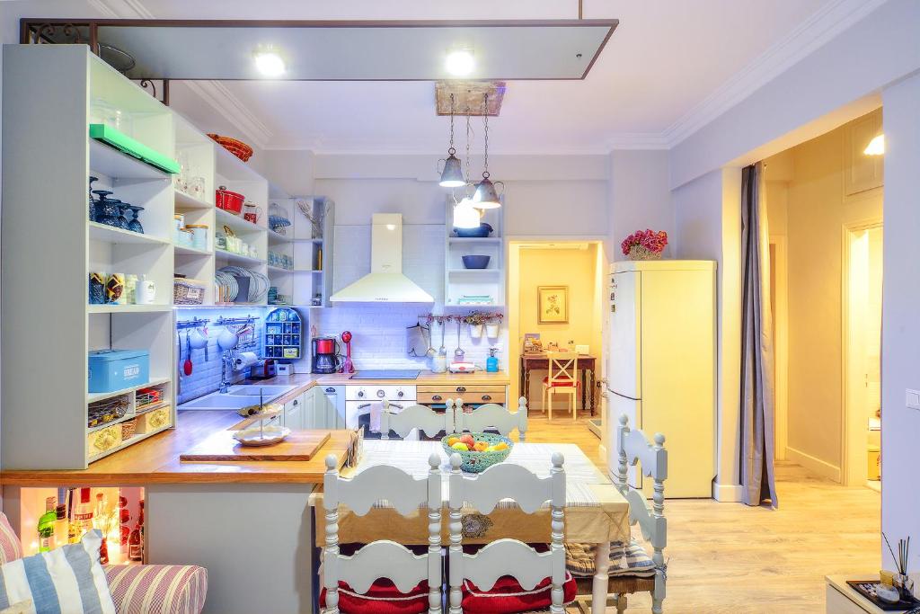 a kitchen and dining room with a table and chairs at Contessina Apt. in Corfu