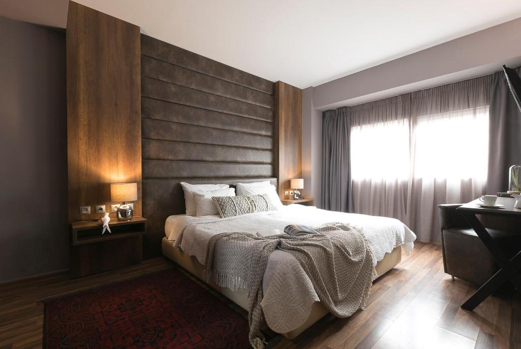 a bedroom with a large bed and a window at Plaza Hotel, Philian Hotels and Resorts in Thessaloniki