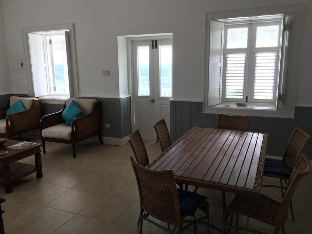 a dining room with a table and chairs and windows at The Atlantis Historic Inn in Saint Joseph