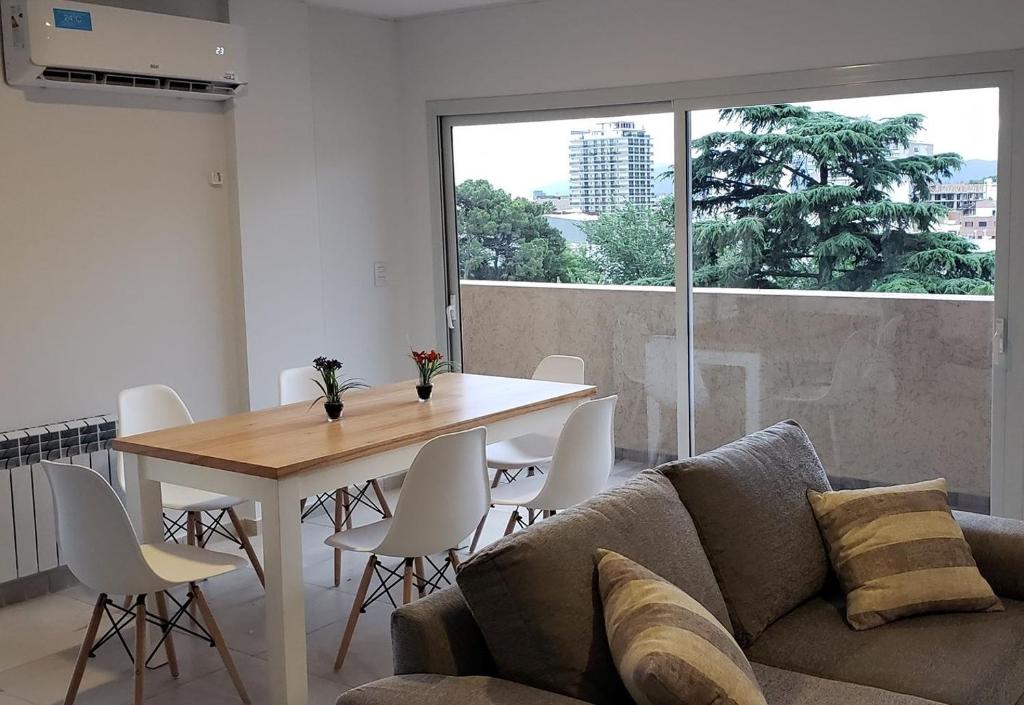 a living room with a table and a couch at Torre del Lago I in Villa Carlos Paz