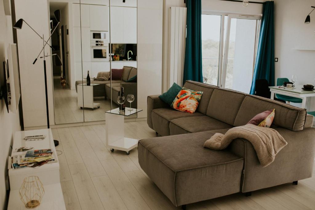 a living room with a couch and a table at NG New Gardens Apartment in Poznań