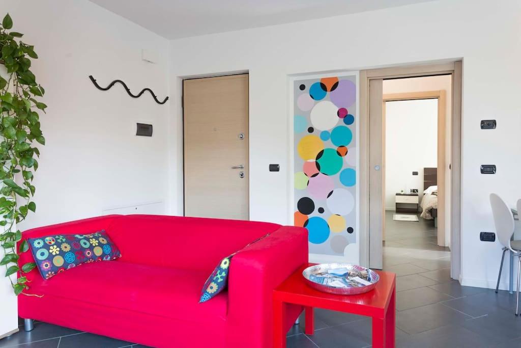 a red couch in a living room with a table at Peace apartment in Arco