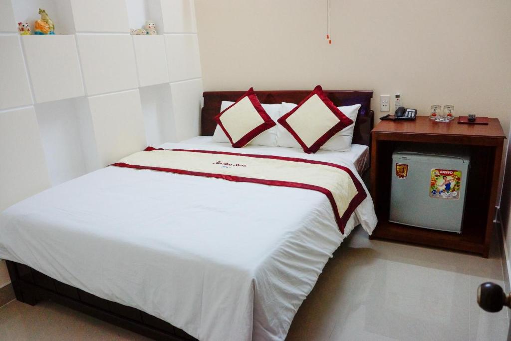 A bed or beds in a room at Lucky Star Hotel