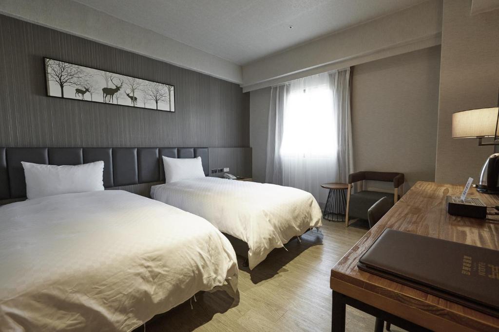 Ένα ή περισσότερα κρεβάτια σε δωμάτιο στο Fulidun Hotel Kenting