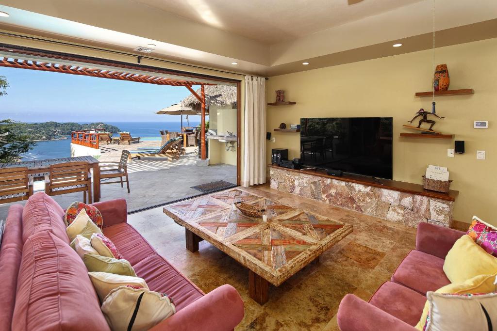 a living room with a couch and a table at Villas Piedra Blanca in Sayulita