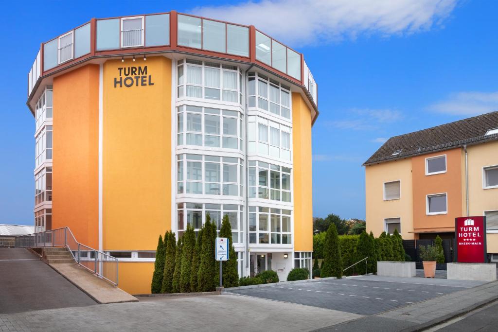 un edificio alto con un cartel de hotel giratorio en él en Turmhotel Rhein-Main, en Dreieich