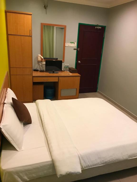 Postel nebo postele na pokoji v ubytování Kangsar Hotel