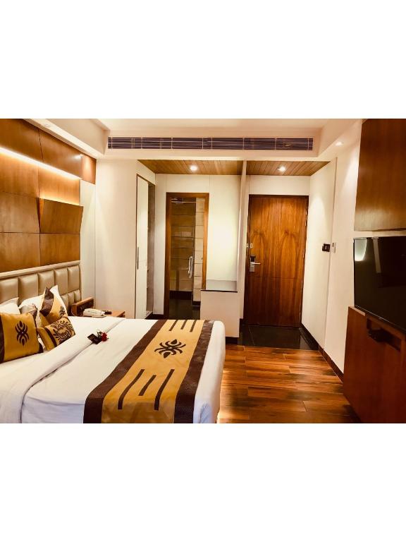 Postel nebo postele na pokoji v ubytování JRD Pride-Business Hotel
