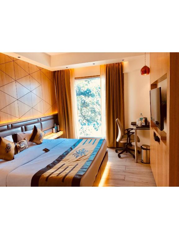 Postel nebo postele na pokoji v ubytování JRD Pride-Business Hotel