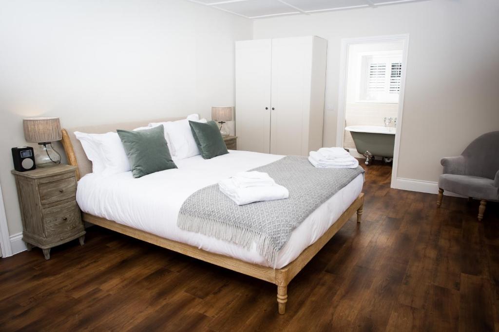 a bedroom with a large bed and a bath tub at The Fox in Winchester