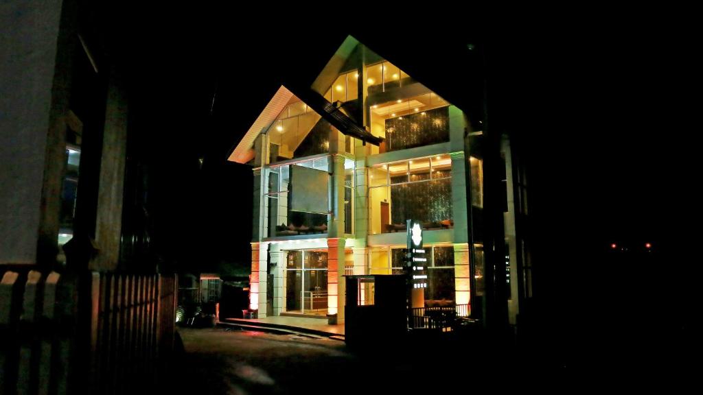 un gran edificio por la noche con luces encendidas en Lourdes Hotel, en Nuwara Eliya