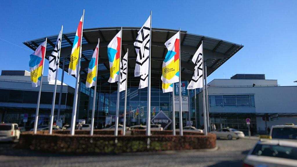 a bunch of flags in front of a building at Apart Hotel Messe Munich - my room Apartments in Munich