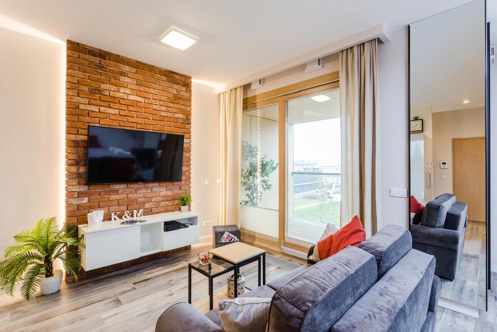 a living room with a couch and a tv at K&M Apartments in Warsaw