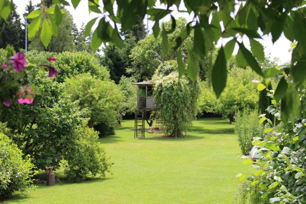 a garden with a tree house in the middle at Apartment Rietheim in Rietheim-Weilheim