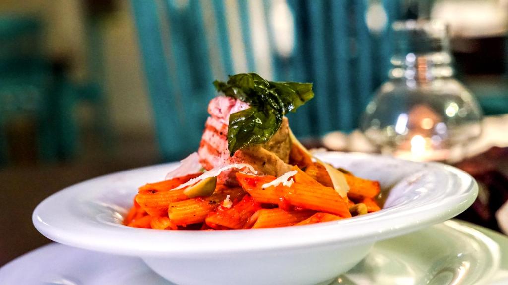 a white plate of food on a table at BeachMirissa Hotel in Mirissa