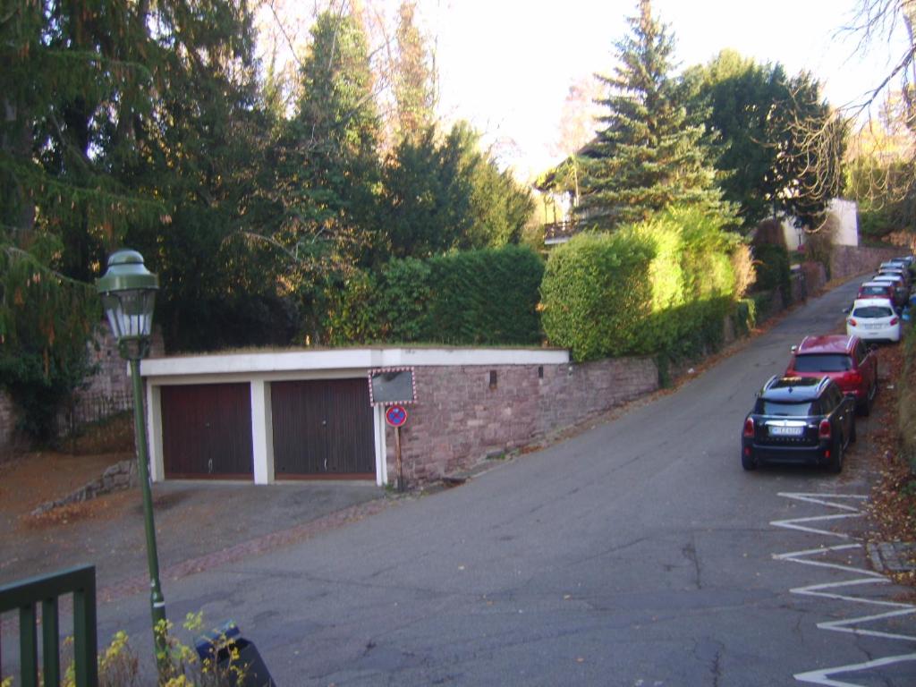 a street with cars parked on the side of a road at Garden Apartment in Baden-Baden