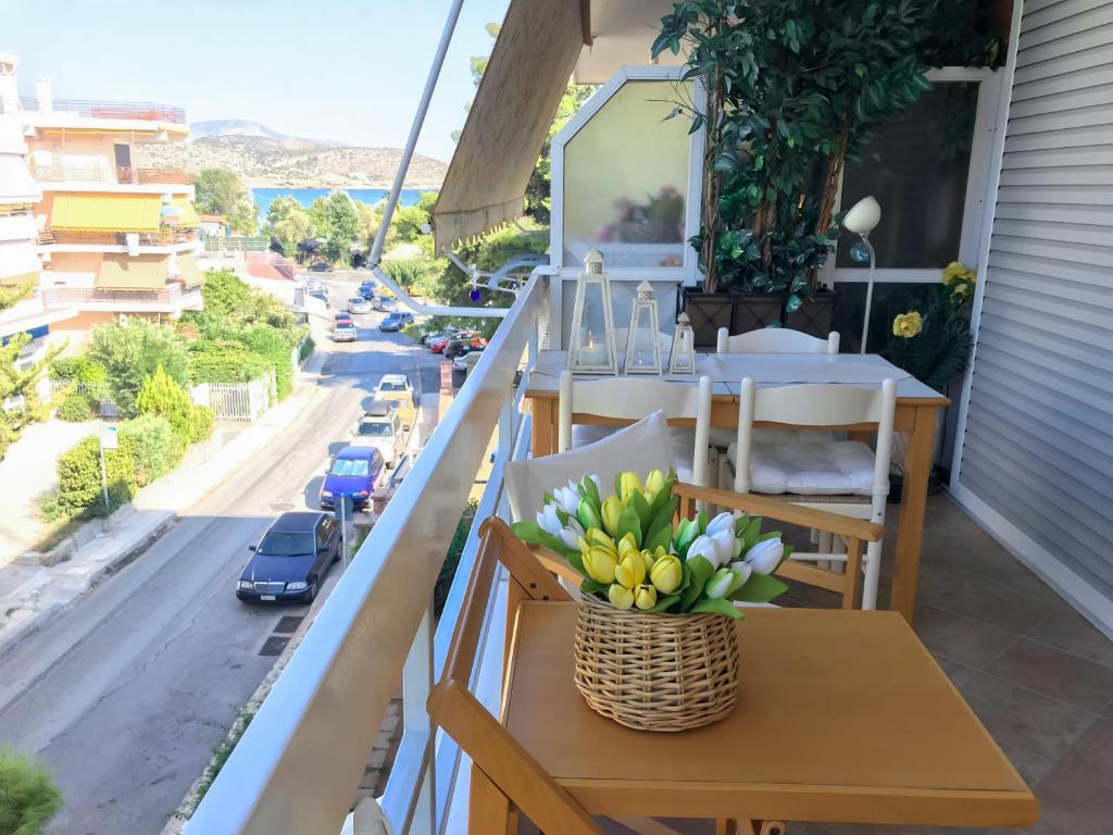a table on a balcony with a view of a street at Kerry's Cosy Apartment in Vari