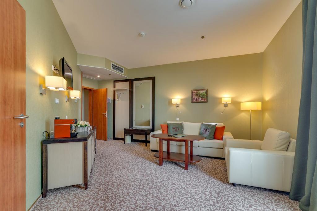 a living room with a couch and a table at New Peterhof Hotel in Petergof