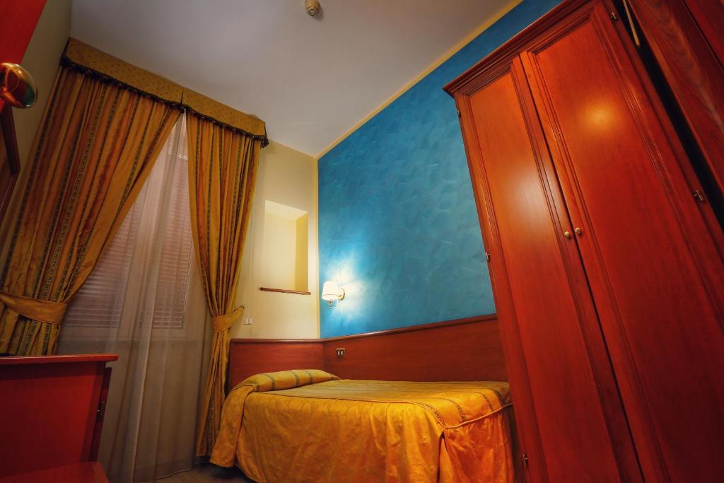 Postel nebo postele na pokoji v ubytování Hotel Giolitti