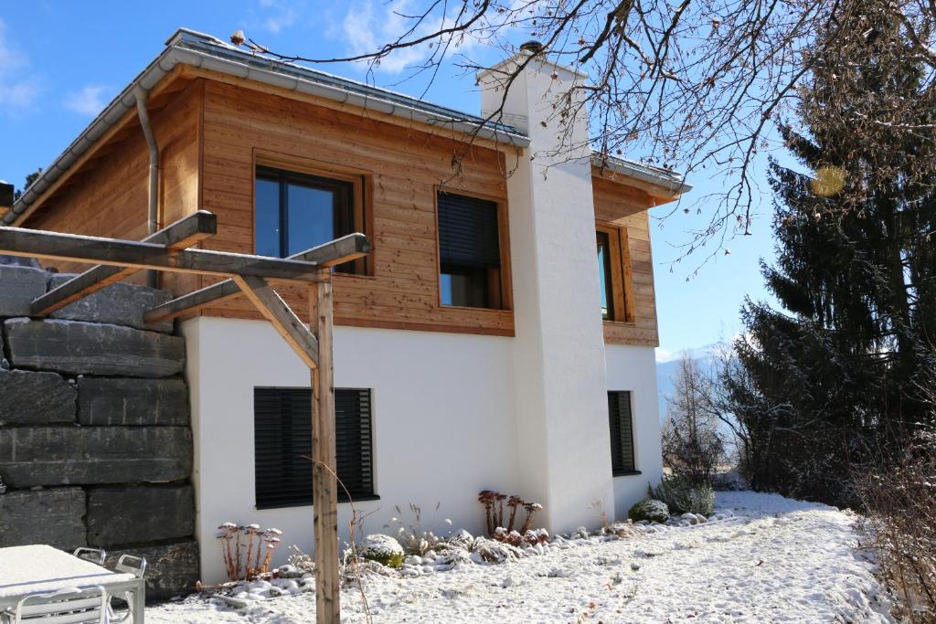 ein Haus mit einem Kreuz davor in der Unterkunft Mira Selva in Trin