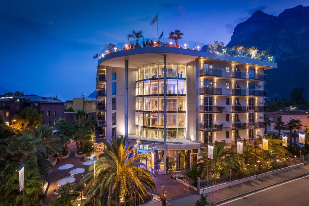 a hotel building with a lot of lights on it at Hotel Kristal Palace - TonelliHotels in Riva del Garda