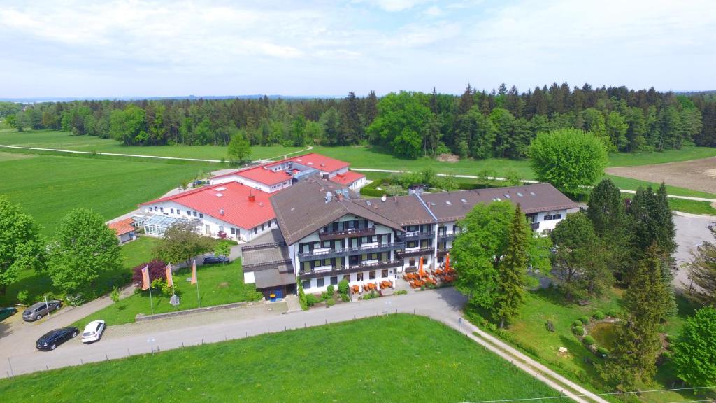 an aerial view of a large house with red roofs at Farbinger Hof in Bernau am Chiemsee