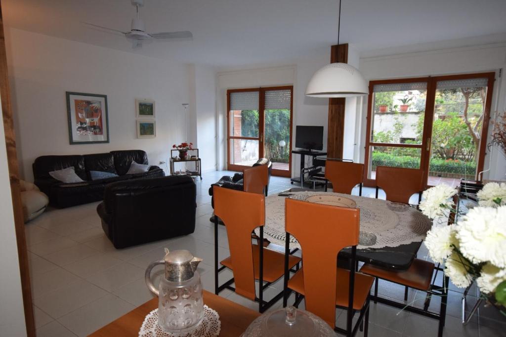 a living room and dining room with a table and chairs at Sun Terrace Sorrento in Sorrento