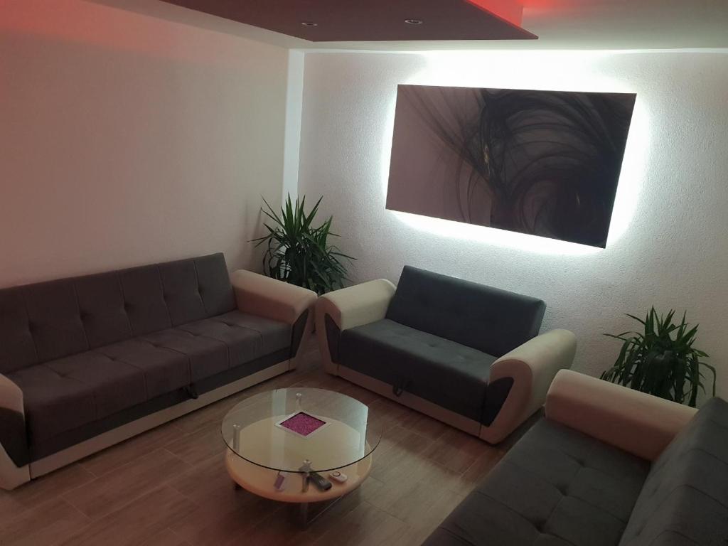 a living room with two couches and a coffee table at KAĆA APARTMANI 1 in Banja Luka