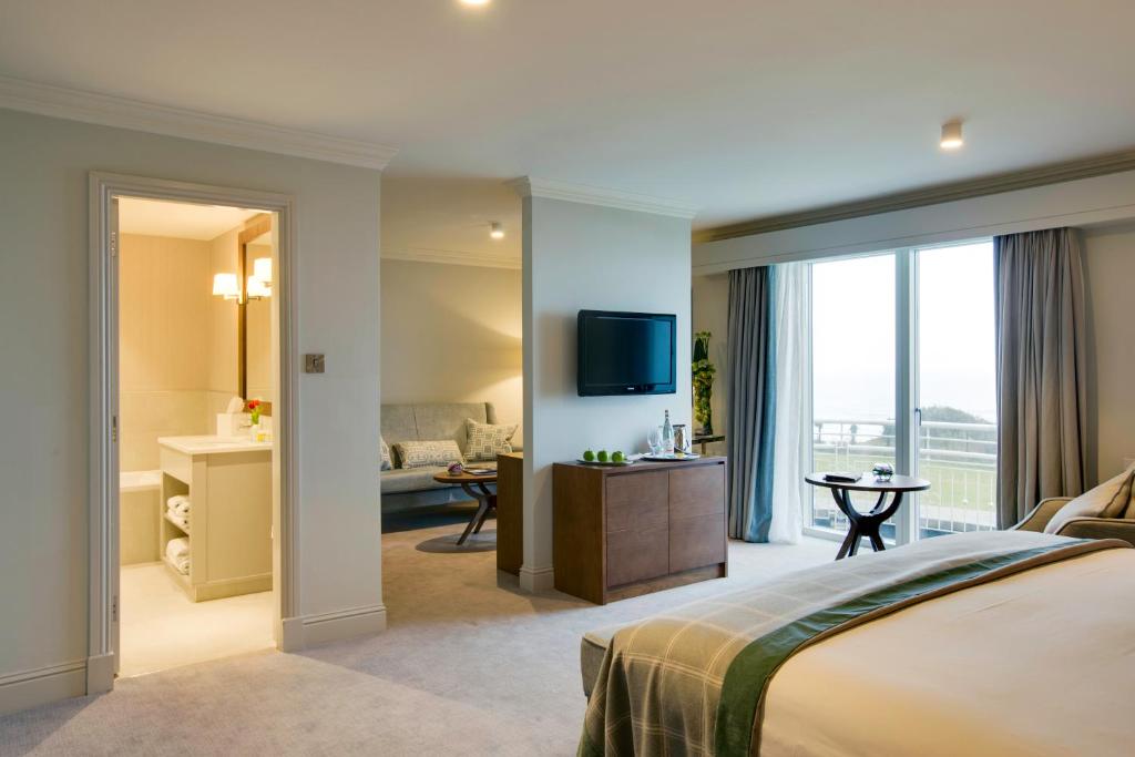 a hotel room with a bed and a bathroom at Portmarnock Resort & Jameson Golf Links in Portmarnock