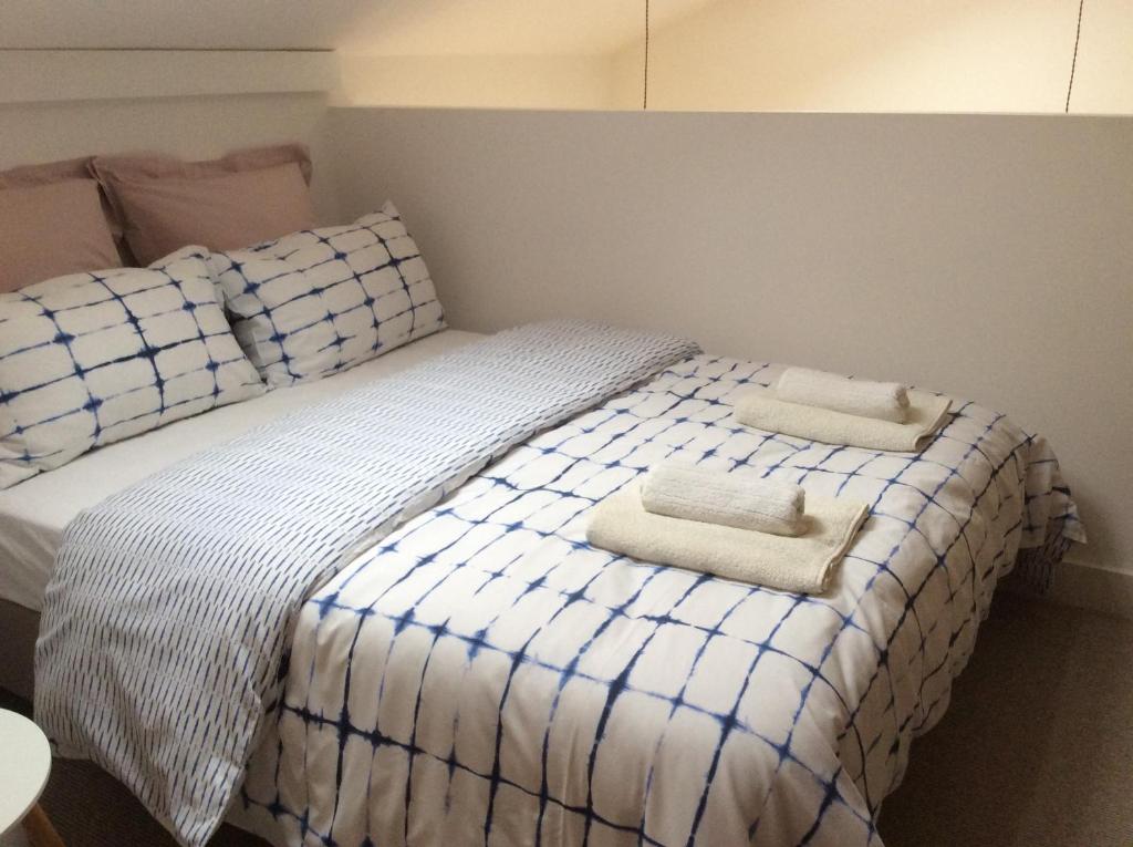 a bedroom with a bed with two towels on it at Passengers House in Whitstable