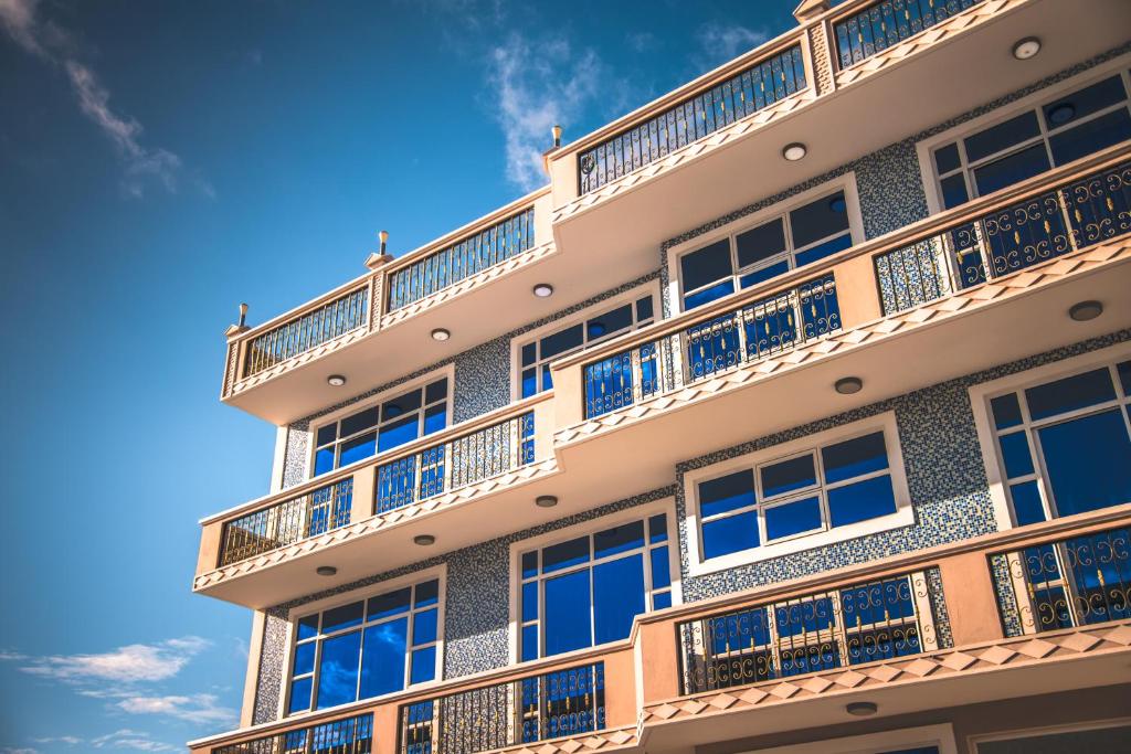 a building with balconies on the side of it at Abuharee Grand in Hithadhoo