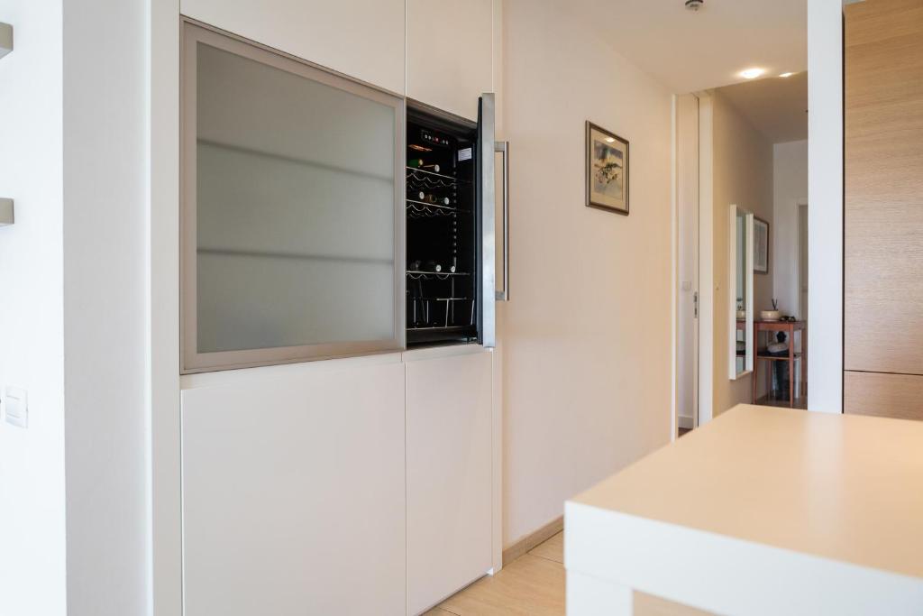 a kitchen with white walls and a window at Apartments Blue Maris Žnjan in Split