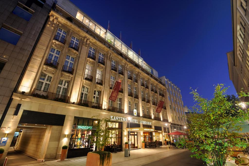a building on a street at night at Kastens Hotel Luisenhof in Hannover