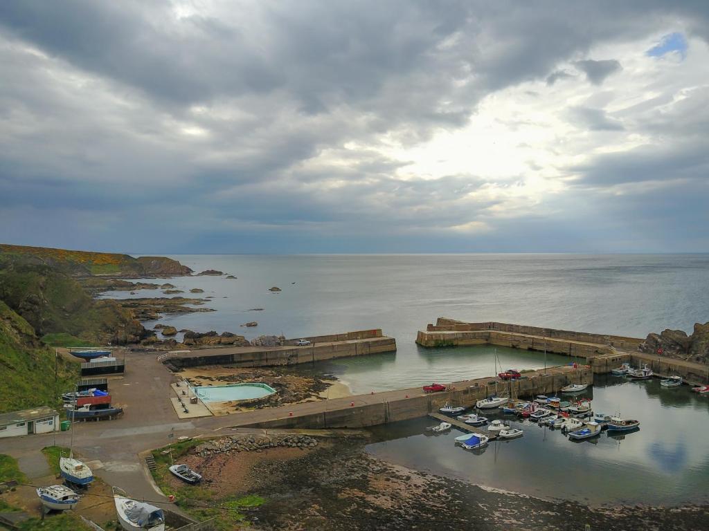 an aerial view of a marina with boats in the water at Portknockie 17 Harbour Place Overlooking Harbour in Portknockie