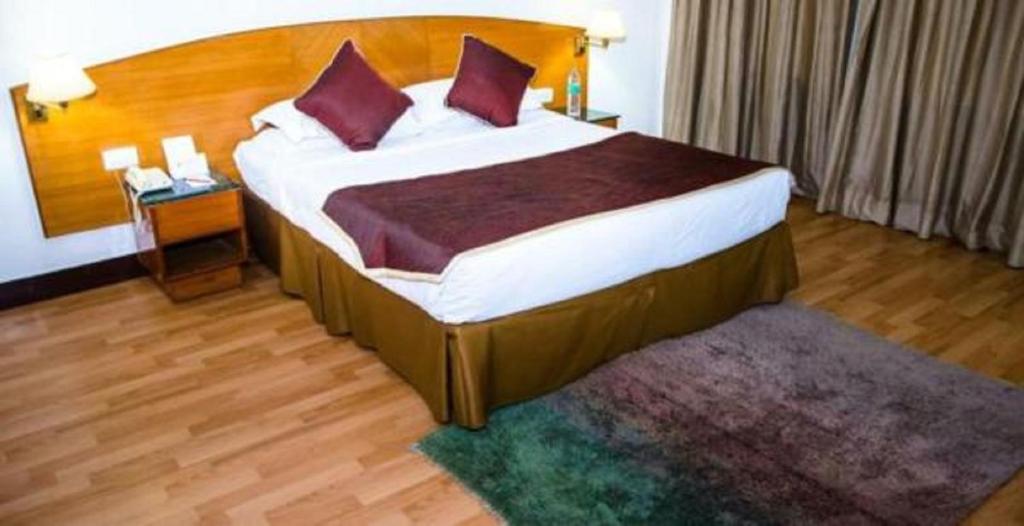 Postel nebo postele na pokoji v ubytování Ramee Guestline Tirupati