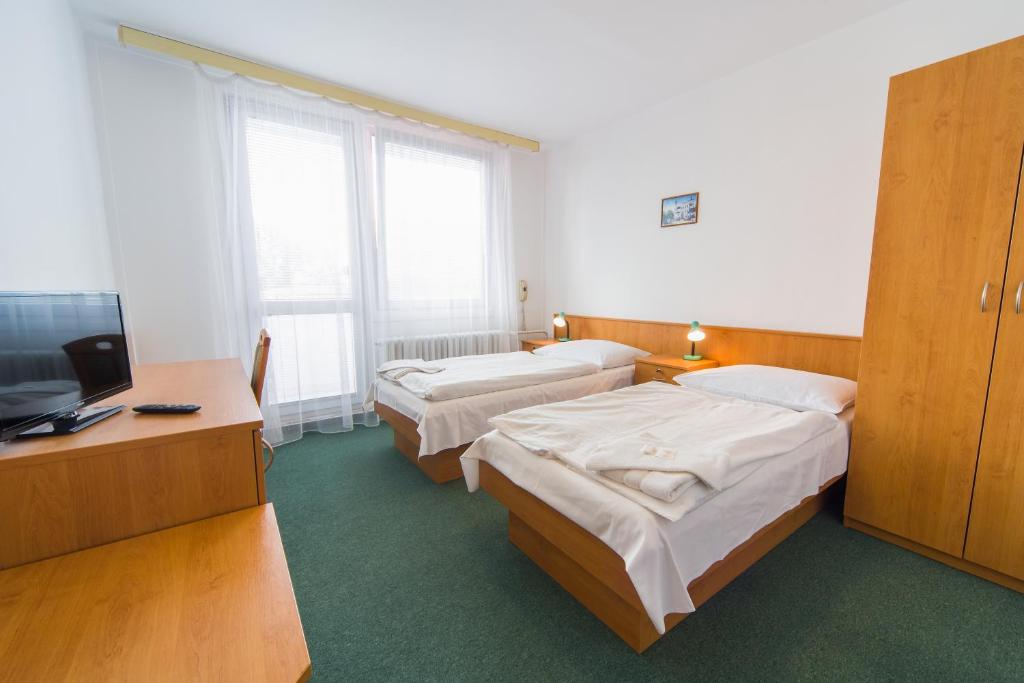 Posteľ alebo postele v izbe v ubytovaní Hotel Arnost Garni