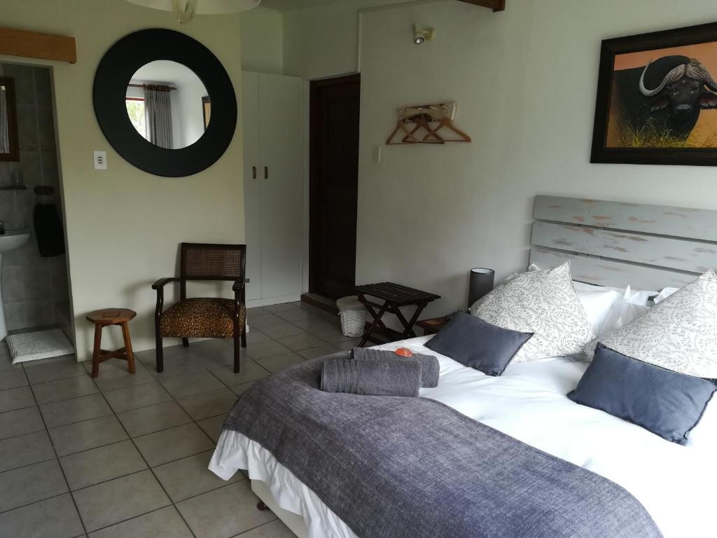 a bedroom with a large bed and a mirror at Apartment in Heather Park in George