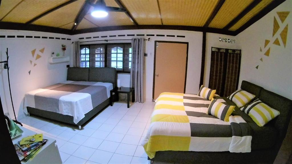 a bedroom with two beds in a room at Sabandy House B&B in Kampung Padang Masirat