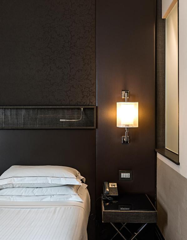 Postel nebo postele na pokoji v ubytování Rome Times Hotel