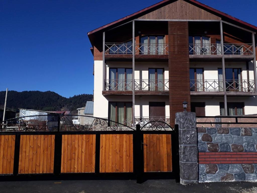 a house with a wooden fence in front of it at Villa Bakuriani in Bakuriani