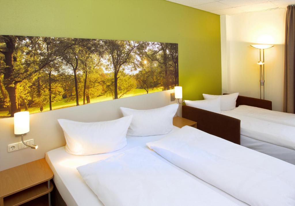 Postel nebo postele na pokoji v ubytování Anders Hotel Walsrode