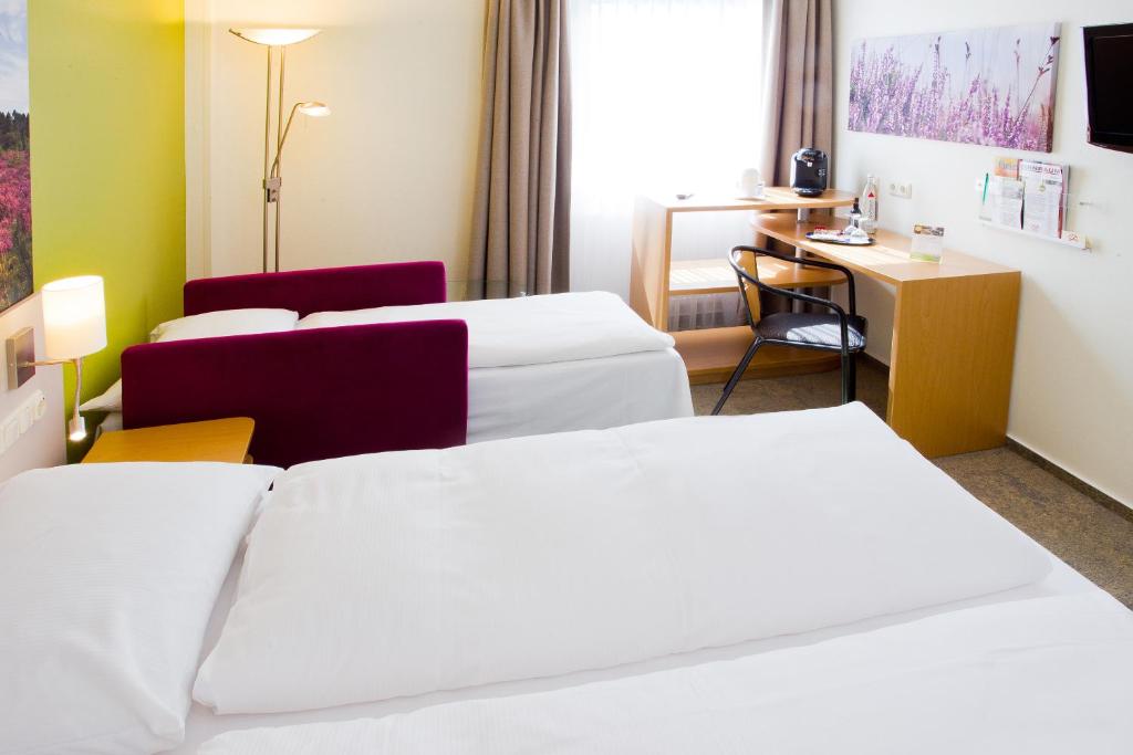 Postel nebo postele na pokoji v ubytování Anders Hotel Walsrode