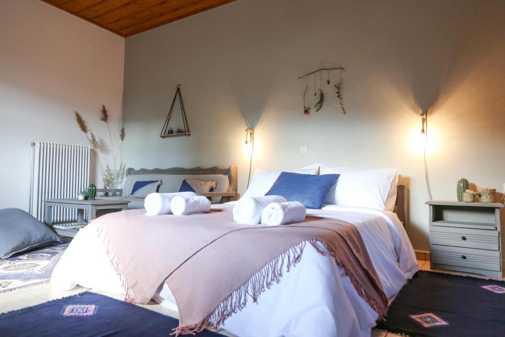 a bedroom with a large bed with towels on it at Orias Guesthouse & Farm in Kalavrita
