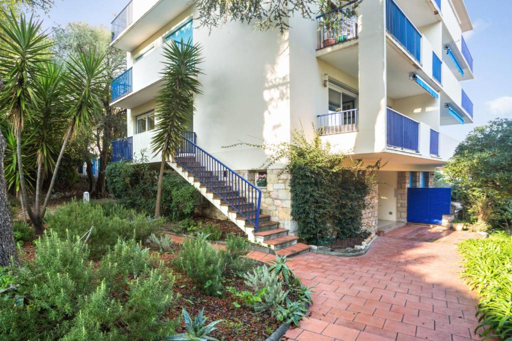 an exterior view of a building with stairs and plants at Appartement Oasis - Welkeys in Antibes